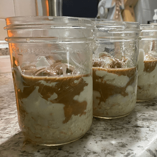 nut butter, yogurt, milk and oats in mason jar