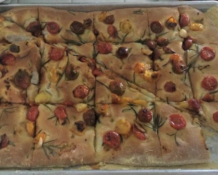 This easy recipe for Rustic Focaccia is a soft bread, with a little crispness topped with olive oil, grape tomatoes, and rosemary.
