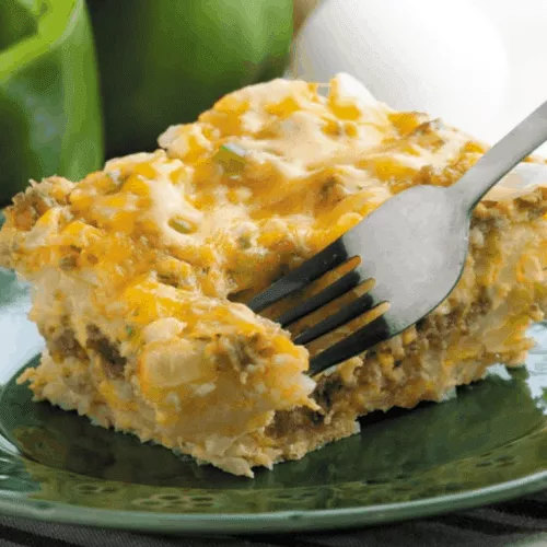 slow cooker hashbrown casserole on plate with fork