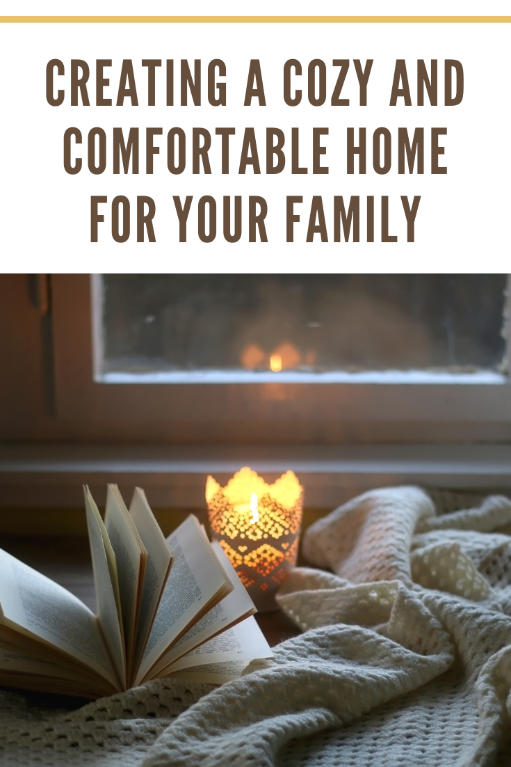 cozy home with candle, book and blanket