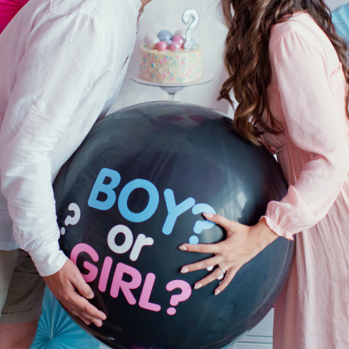 man and woman holding black balloon with boy or girl on gender reveal party (1)