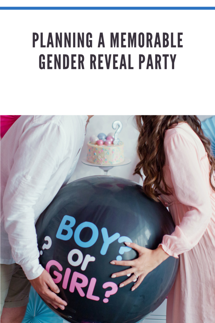 man and woman holding black balloon with boy or girl on gender reveal party