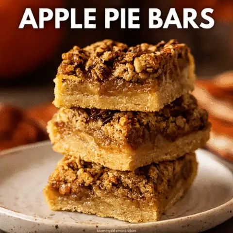 Stacked apple pie bars on a rustic ceramic plate, featuring a golden buttery crust, gooey cinnamon apple filling, and crumbly pecan topping. Warm autumn tones and soft lighting evoke a cozy fall vibe, with pumpkins and dried leaves in the blurred background. Text overlay reads: &ldquo;Forks? Overrated. These bars are handheld heaven.&rdquo; Subtitle: &ldquo;Apple Pie Bars.&rdquo; Bottom tagline: &ldquo;Crust goals. Filling dreams. Topped with crunch.&rdquo;