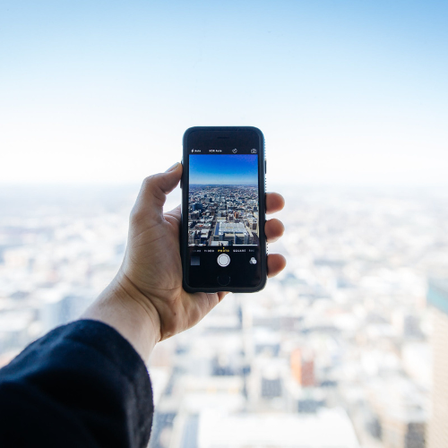 photo of city on cellphone with city in background
