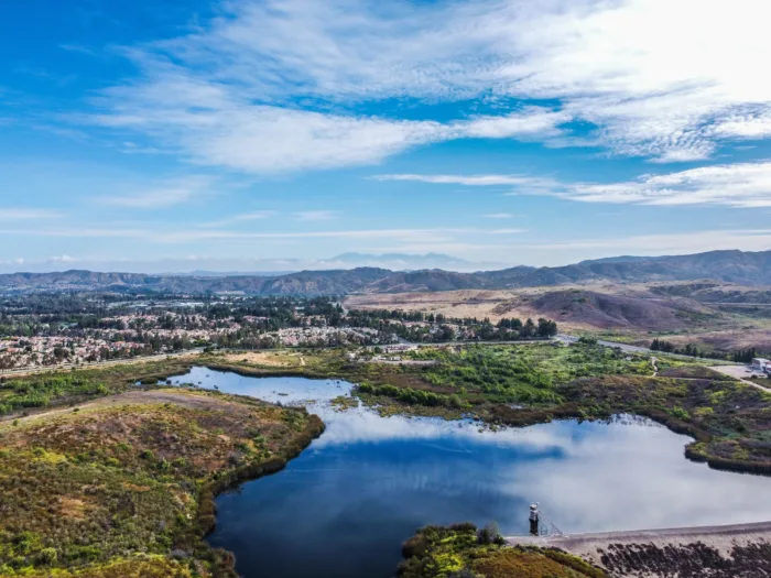 Aerial view of a lake in Irvine surrounded by mountains