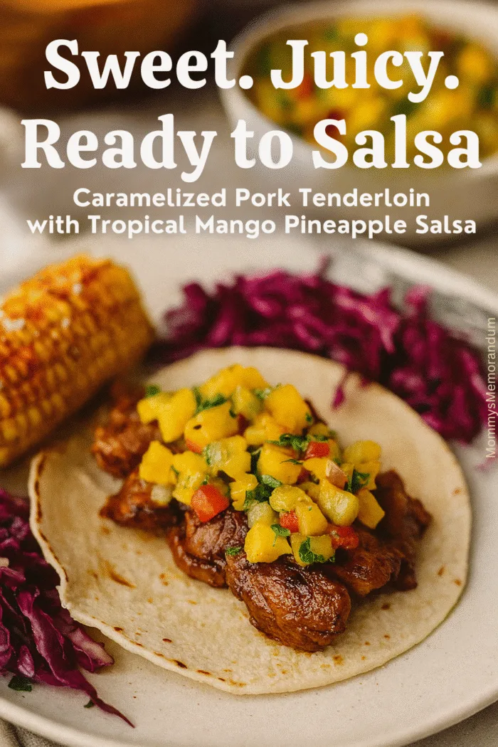 Caramelized pork tenderloin on a corn tortilla topped with mango pineapple salsa, with Mexican street corn and purple cabbage slaw in the background