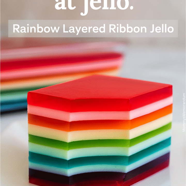 Close-up of a vibrant Rainbow Layered Ribbon Jello slice with alternating translucent and creamy layers, styled on a white plate with a cheeky tagline overlay reading &ldquo;You had me at jello.&rdquo;