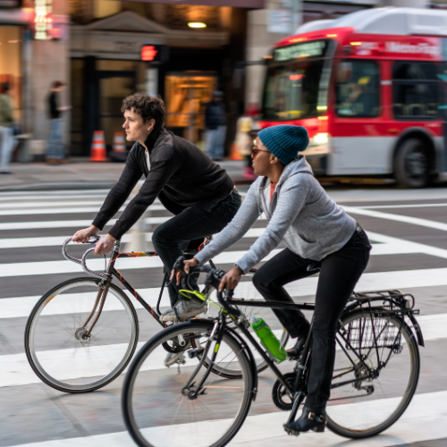 two people cycling in the city