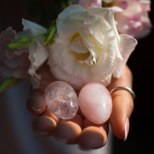 yoni eggs in hand with white rose