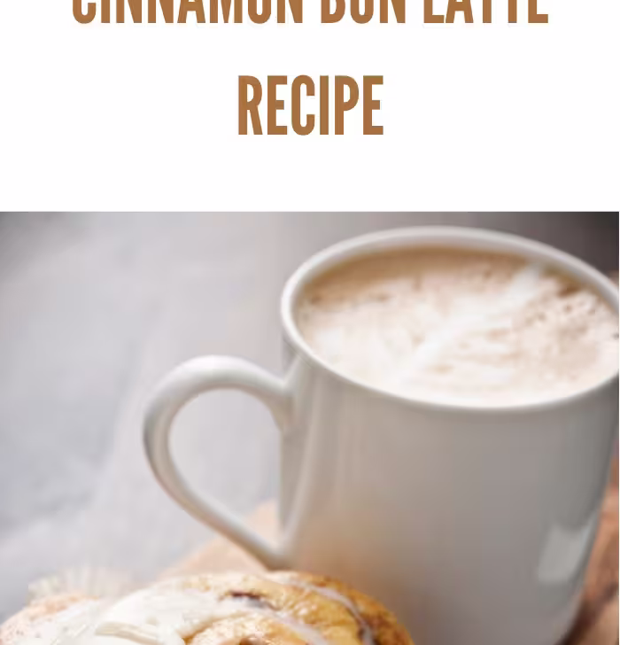 A delicious cinnamon bun latte served with a frosted cinnamon roll