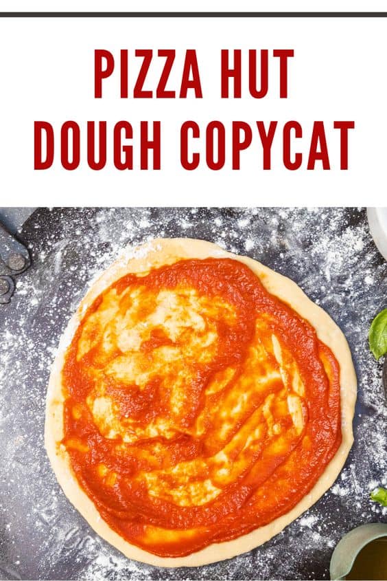 Fresh pizza dough topped with tomato sauce, replicating the Pizza Hut dough recipe.