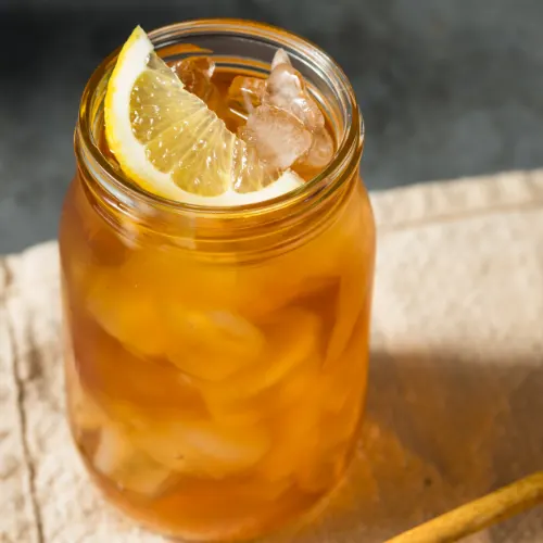 Overhead view of copycat Arizona iced tea with lemon wedge in a mason jar