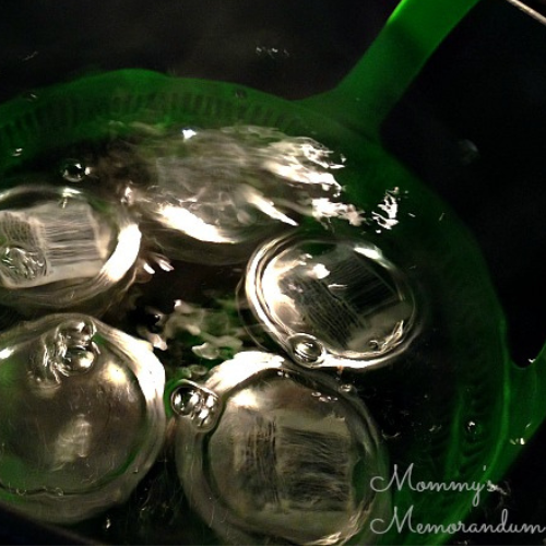 Sangria jelly jars in a water bath canner, preparing for sealing and preservation.