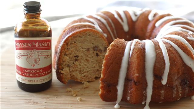 Moist sweet potato bundt cake displayed next to Nielsen-Massey Mexican Pure Vanilla Extract