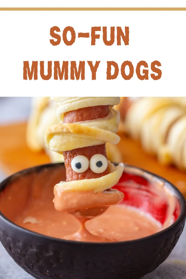 Mummy dog dipped in ketchup, showcasing an easy and fun Halloween recipe for kids and parties