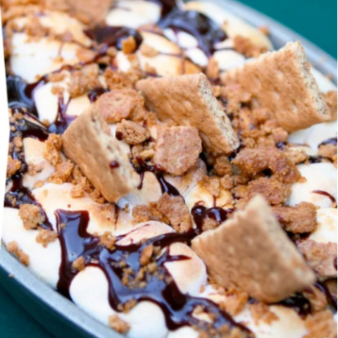 Delicious ooey-gooey brownie s'mores with golden toasted marshmallows and rich hot fudge sauce