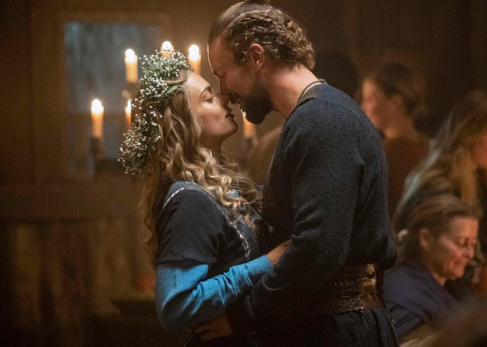 A couple shares a tender moment in Vikings: Valhalla: The Complete First Season amidst Viking drama.