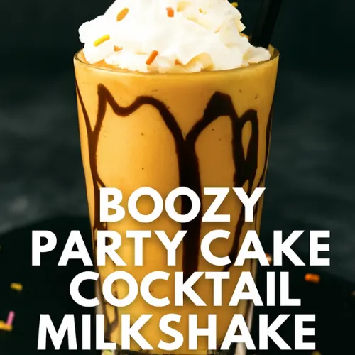 Boozy party cake cocktail milkshake in a clear glass with chocolate drizzle, topped with whipped cream, colorful sprinkles, and a black fondant cat silhouette standing upright in the center. Halloween-themed adult dessert drink with cheeky overlay text: &lsquo;BOOZY PARTY CAKE COCKTAIL MILKSHAKE &ndash; DIG IN, GROWNUPS (and bring friends)&rsquo;.&rdquo;