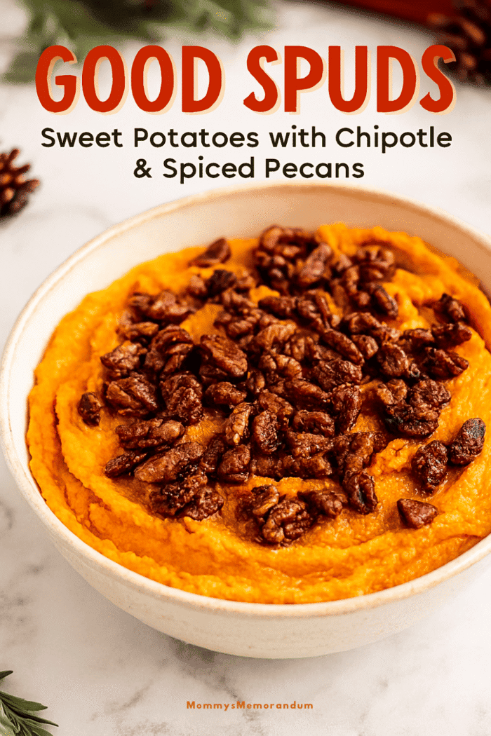 High-resolution image of creamy orange sweet potato mash topped with glossy spiced pecans, served in a rustic ceramic bowl. Styled with festive holiday decor including pine sprigs and warm lighting, perfect for a Thanksgiving or holiday table.