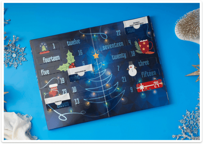 Open Adagio Teas Advent Calendar showing numbered pockets and a teacup &mdash; inside view of the 24-tea calendar