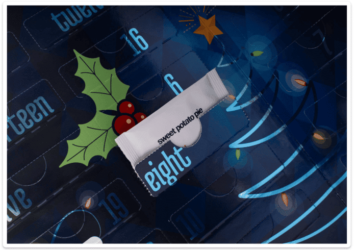 Close-up showing Sweet Potato Pie tea packet inside the Adagio Tea Advent Calendar pocket &mdash; holiday tea variety close up