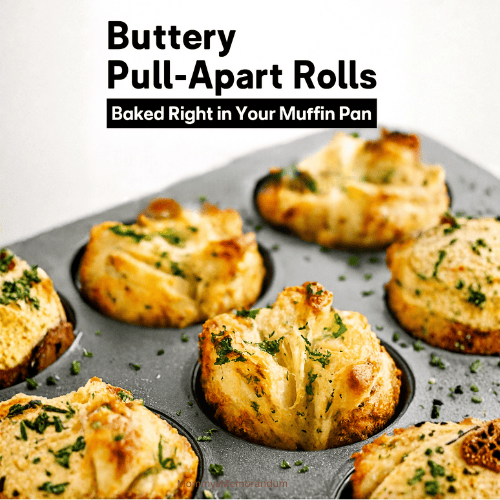 Golden, flaky Herbes de Provence pull-apart rolls baked in a muffin pan, brushed with parsley butter and styled for a cozy dinner spread. The rolls are glistening and aromatic, with visible layers and herb flecks, captured in bright natural light.
