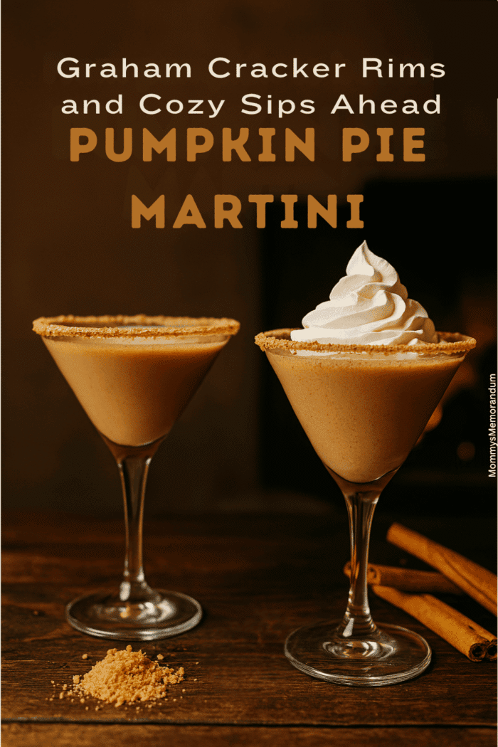 Two Pumpkin Pie Martinis on a rustic table, one topped with whipped cream, both rimmed with graham cracker crumbs, styled with warm lighting and cozy holiday decor