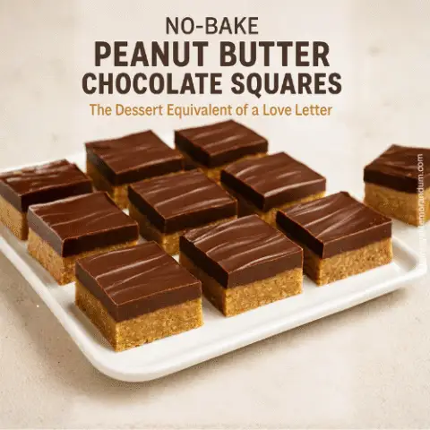 Close-up image of no-bake peanut butter chocolate squares arranged on a white platter. Each square features a crumbly peanut butter-graham base topped with smooth, glossy chocolate. Text overlay reads &ldquo;Love at First Bite&rdquo; and &ldquo;No-Bake Peanut Butter Chocolate Squares That Never Last Long&hellip;&rdquo; in warm tones. Cozy kitchen background softly blurred.
