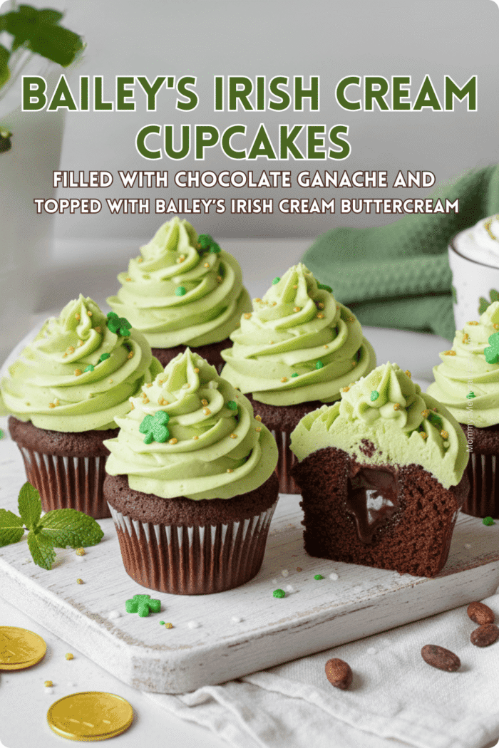 Baileys Irish Cream Cupcakes with Chocolate Ganache Baileys Irish Cream cupcakes topped with tall swirls of Irish cream buttercream frosting, filled with chocolate ganache, styled with a bottle of Baileys and hot cocoa on a wooden surface