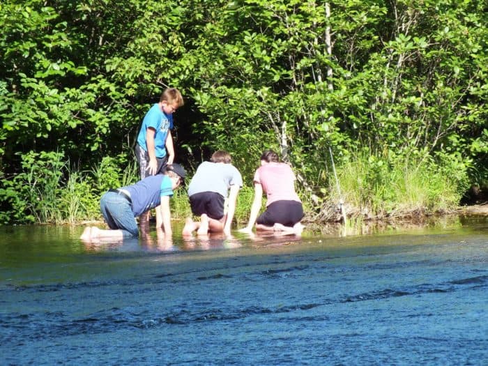 Since Cooper caught a fish with his bare hands, they've all decided to join him.