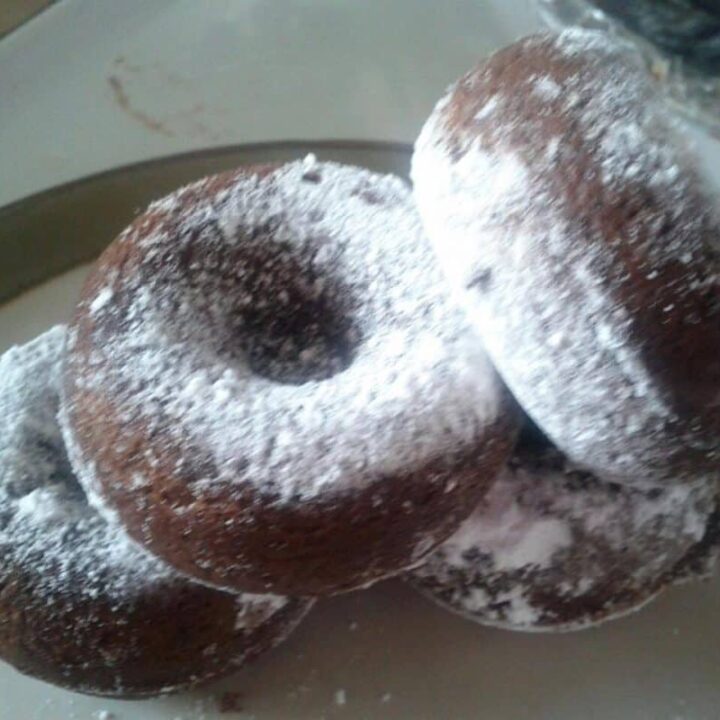 chocolate donuts sprinkled with powdered sugar