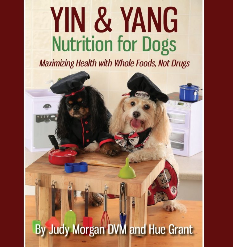 Two dogs dressed as chefs in a kitchen, promoting the book 'Yin & Yang Nutrition for Dogs' by Judy Morgan and Hue Grant.