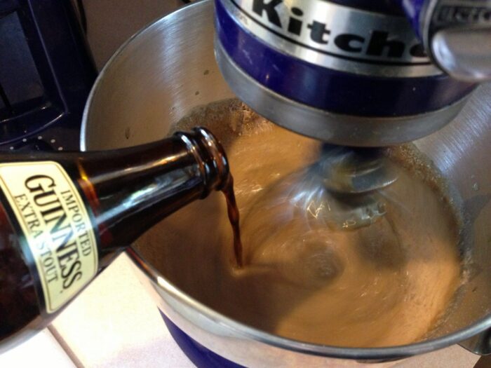 Guinness stout being poured into cupcake batter
