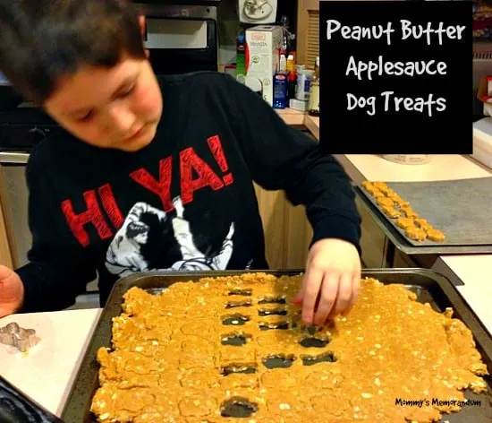 Peanut Butter-Applesauce Dog Treats cookie cutter being used to cut out rolled dough