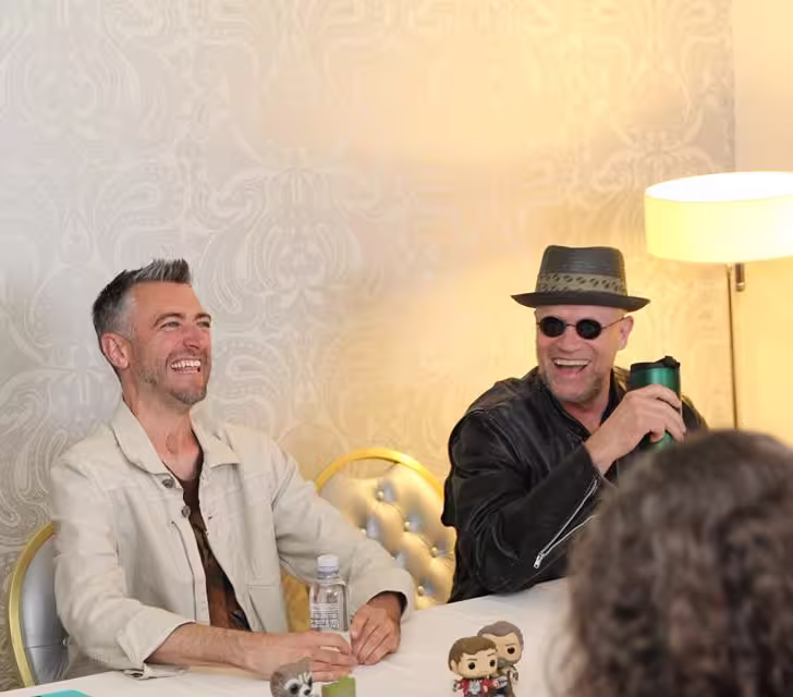 Sean Gunn laughing with Michael Rooker