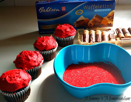 apple cupcakes iced with mound of red icing