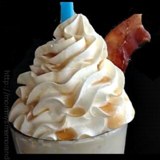 Bacon milkshake topped with whipped cream, crispy bacon, and maple syrup drizzle for a savory-sweet treat.