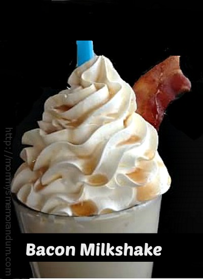 Bacon milkshake topped with whipped cream, crispy bacon, and maple syrup drizzle for a savory-sweet treat.