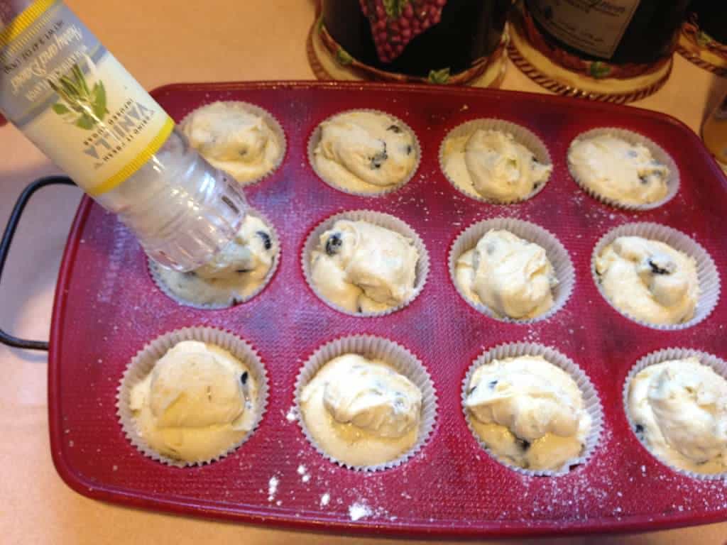 blueberry muffins adding sugar to top of muffins