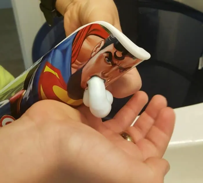 Superman-themed Crazy Foam being dispensed onto a person's hand, capturing the fun and nostalgia of this classic bathtime product.