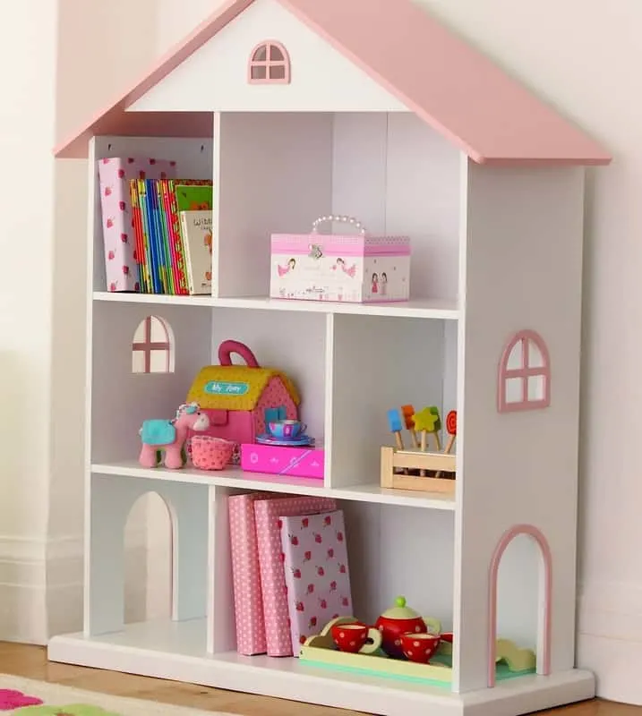 Kids room with dollhouse shelving used as a creative storage solution for toys and books.