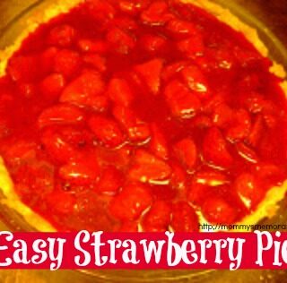 Close-up of a fresh strawberry gelatin pie in a baked crust, topped with whipped cream