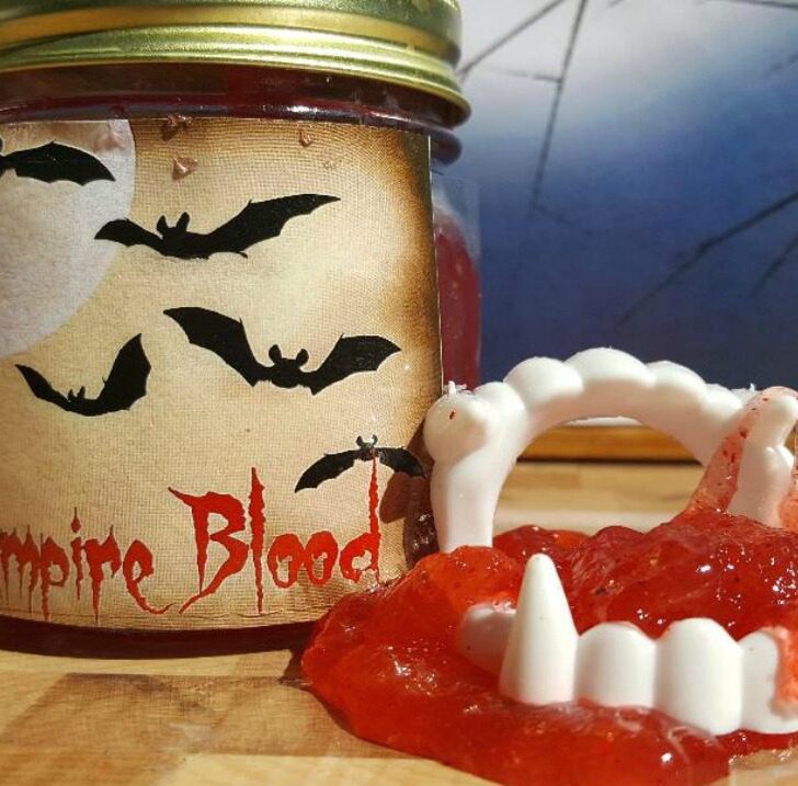 Edible Glow-In-The-Dark Vampire Blood Slime glowing bright red under black light, ideal for spooky Halloween fun