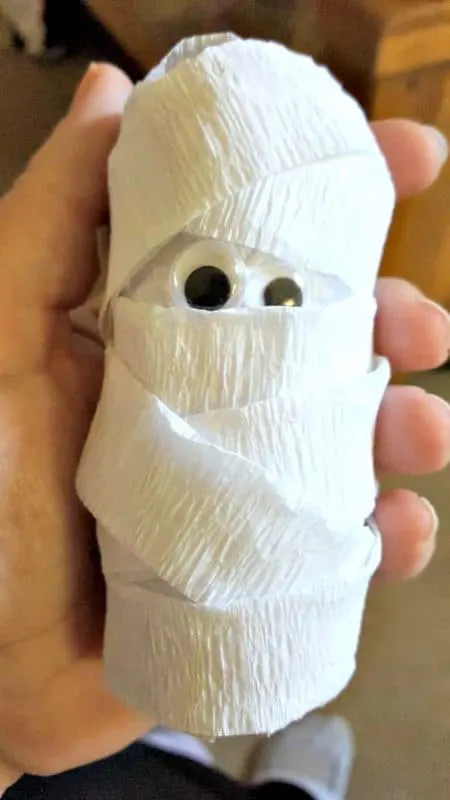 Halloween toilet paper roll mummy craft tutorial using Welch's Fruit Snacks, ideal for party favors and decorations