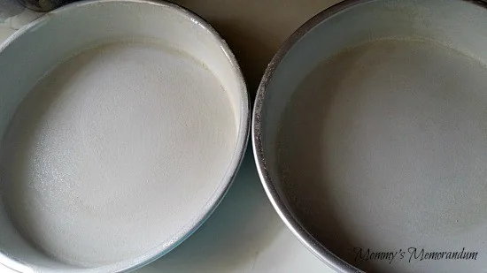 grease and flour your cake pans