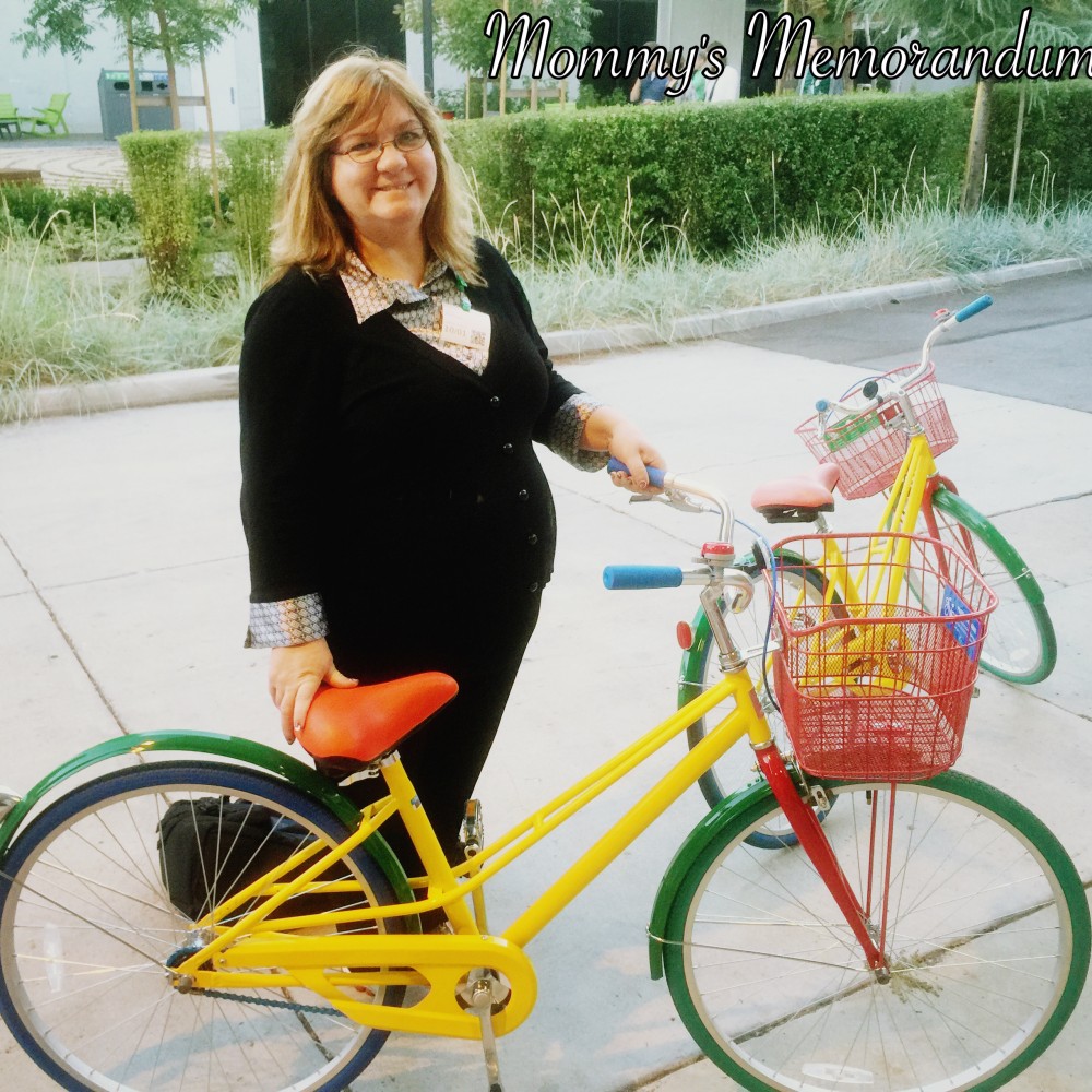 Julee Morrison riding a Google bike on the Google Campus, surrounded by the vibrant and innovative workspace