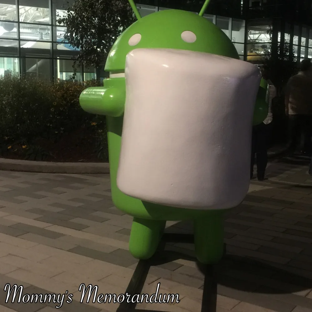 Andy Android statue standing outside Google Headquarters, surrounded by the modern architecture of the Googleplex