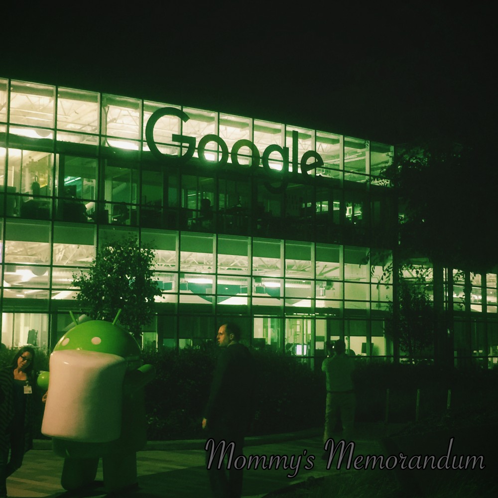 Google Headquarters at night with a brightly lit Andy Android statue and illuminated buildings