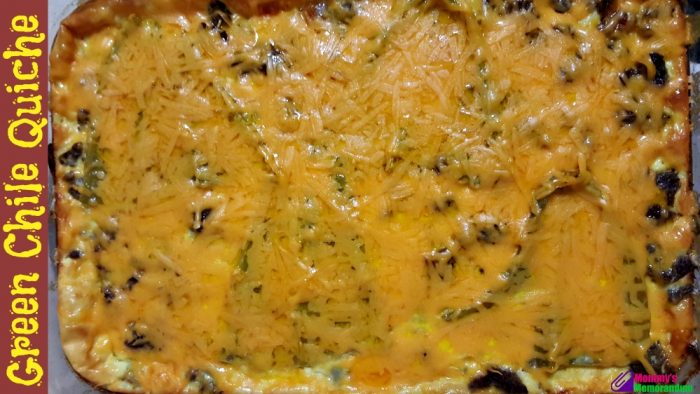 Golden-baked green chile quiche fresh from the oven, showcasing layers of chiles, sausage, and melted cheese.