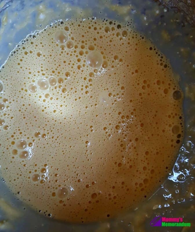 Well-combined eggs and flour in a mixing bowl, prepared for making the batter for a green chile quiche.